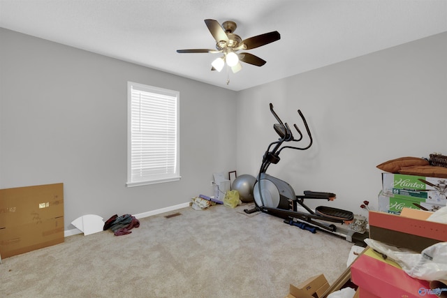 workout area featuring ceiling fan and carpet floors