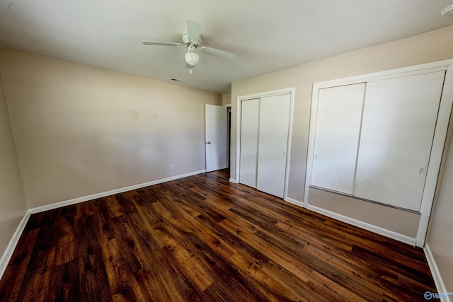 2551 Little Creek Rd, Arab, AL 35016 - unfurnished bedroom featuring multiple closets, dark wood-style flooring, baseboards, and ceiling fan