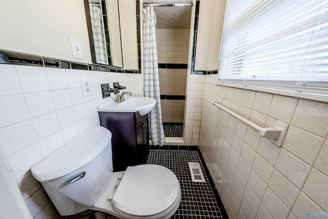 2551 Little Creek Rd, Arab, AL 35016 - full bath with tile walls, a stall shower, toilet, vanity, and tile patterned flooring