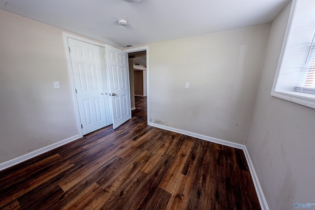 2551 Little Creek Rd, Arab, AL 35016 - unfurnished bedroom with dark wood-style floors, baseboards, and a closet