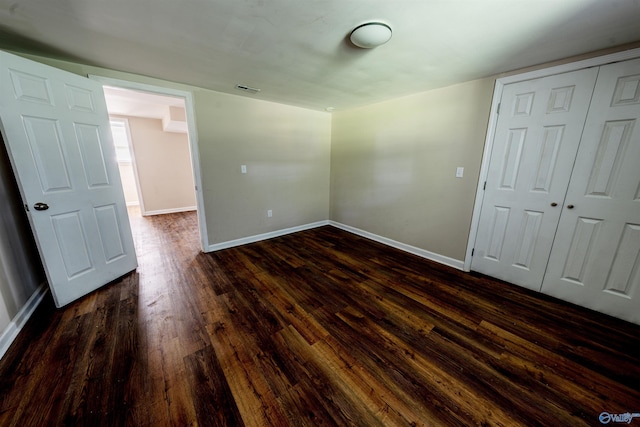 2551 Little Creek Rd, Arab, AL 35016 - unfurnished bedroom featuring dark wood finished floors, baseboards, and a closet