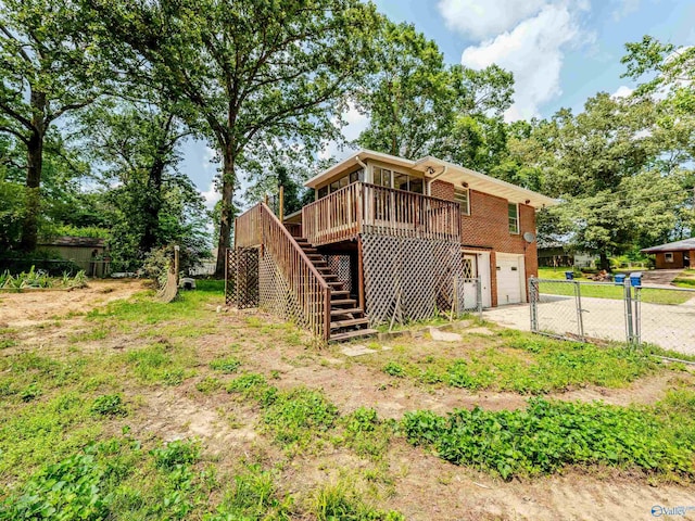 2551 Little Creek Rd, Arab, AL 35016 - rear view of house with stairs, driveway, an attached garage, a deck, and brick siding