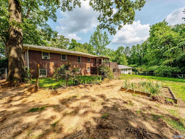 2551 Little Creek Rd, Arab, AL 35016 - rear view of house with a vegetable garden, brick siding, and a deck