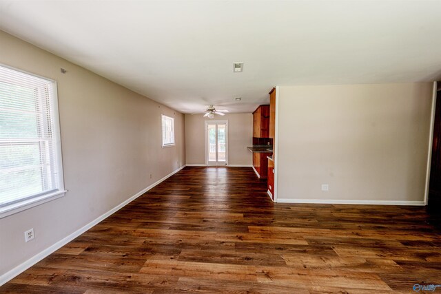 2551 Little Creek Rd, Arab, AL 35016 - unfurnished living room with dark wood-style flooring, baseboards, and ceiling fan