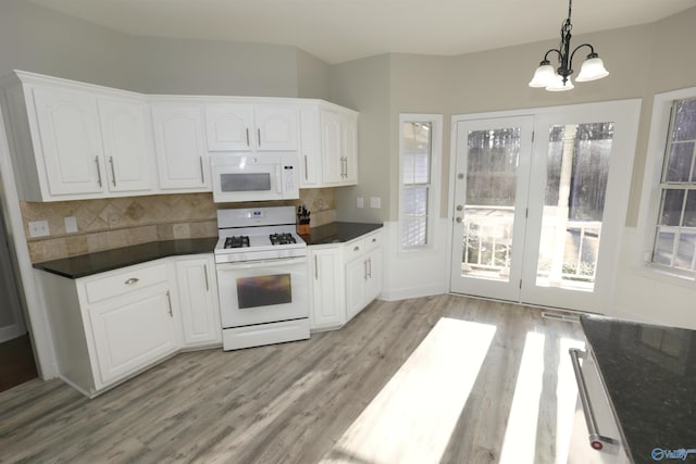 kitchen with pendant lighting, white appliances, tasteful backsplash, white cabinets, and light wood-type flooring