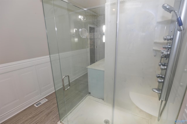 bathroom with hardwood / wood-style floors and walk in shower