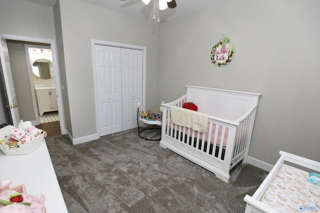 carpeted bedroom with a nursery area, ceiling fan, and a closet