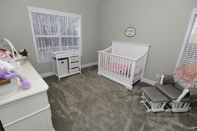 carpeted bedroom featuring a nursery area