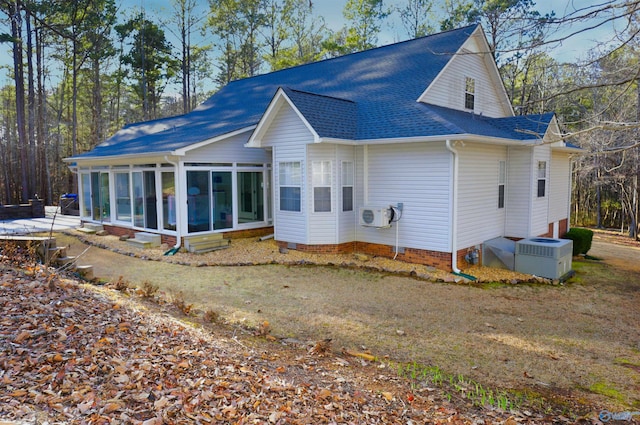 rear view of property featuring a sunroom, central AC, and ac unit