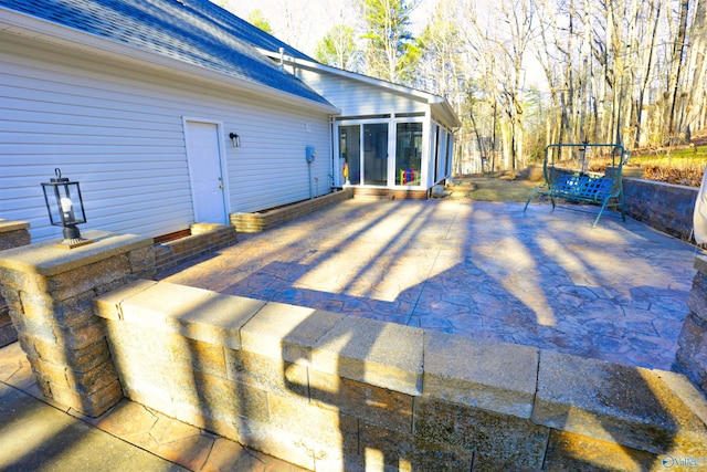 view of patio with a sunroom