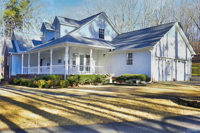 view of front facade with a porch, a garage, and a front lawn