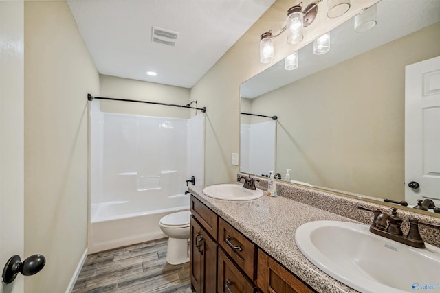 full bathroom with vanity, shower / bathing tub combination, wood-type flooring, and toilet