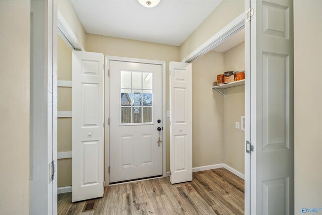 doorway with wood-type flooring