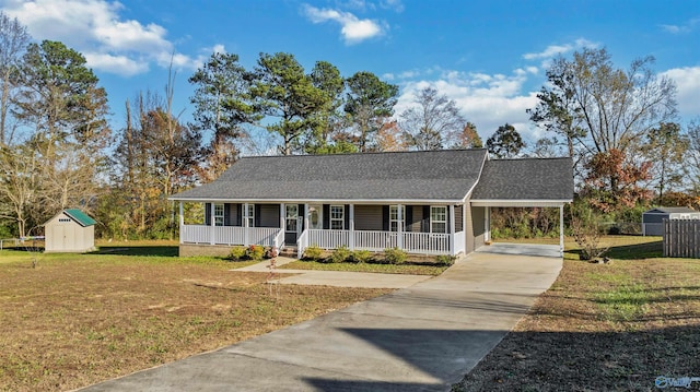 view of front of property featuring a carport, a storage unit, covered porch, and a front lawn