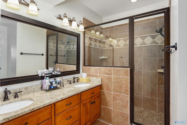 bathroom featuring tile walls, vanity, and a shower with door