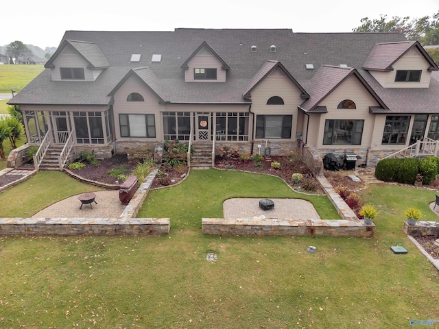 rear view of property featuring a sunroom and a yard