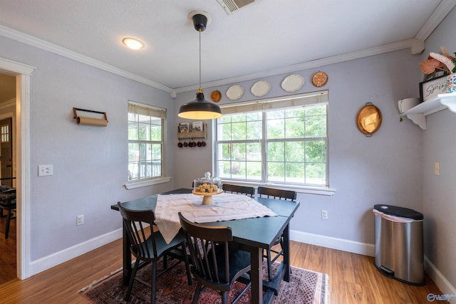 610 Grover Davis Rd, Hamilton, AL 35570 - dining space featuring light wood finished floors, crown molding, and baseboards