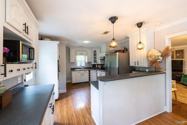 610 Grover Davis Rd, Hamilton, AL 35570 - kitchen with dark countertops, stainless steel fridge, black microwave, a peninsula, and light wood-style floors