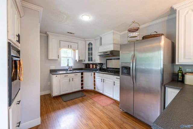 610 Grover Davis Rd, Hamilton, AL 35570 - kitchen with appliances with stainless steel finishes, a sink, dark countertops, white cabinetry, and ornamental molding