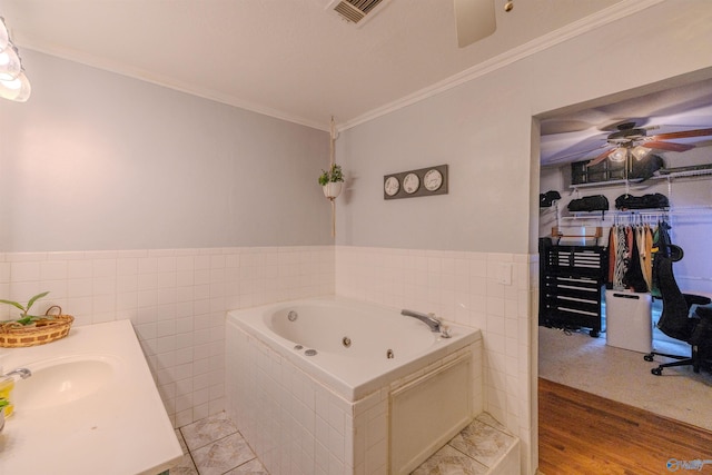 610 Grover Davis Rd, Hamilton, AL 35570 - full bathroom featuring tile walls, a tub with jets, ceiling fan, crown molding, and a sink