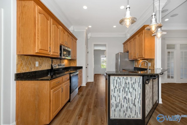 kitchen with recessed lighting, dark stone counters, a peninsula, tasteful backsplash, and appliances with stainless steel finishes