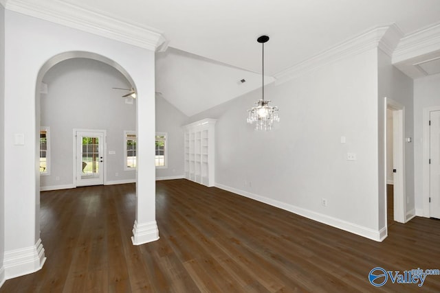 unfurnished dining area featuring arched walkways, vaulted ceiling, dark wood-style flooring, and baseboards