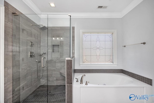 bathroom with a bath, a shower stall, ornamental molding, and visible vents