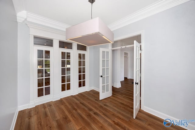 unfurnished room featuring wood finished floors, crown molding, baseboards, and french doors