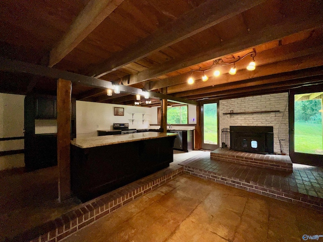 kitchen with beamed ceiling, tile patterned floors, a brick fireplace, and track lighting