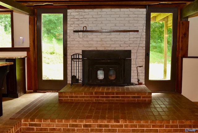 interior details featuring a brick fireplace