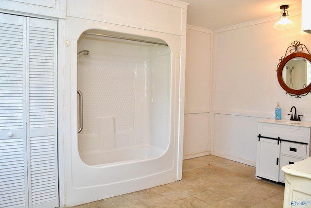 bathroom with shower / bathing tub combination, tile patterned floors, crown molding, and vanity