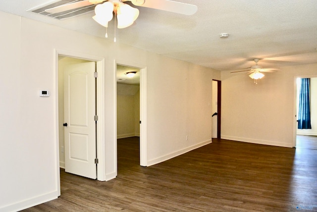 empty room with dark hardwood / wood-style floors, ceiling fan, and a textured ceiling