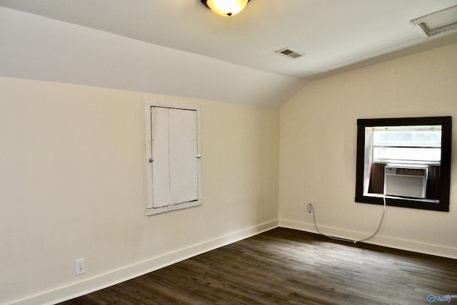 unfurnished room featuring vaulted ceiling, dark hardwood / wood-style floors, and cooling unit