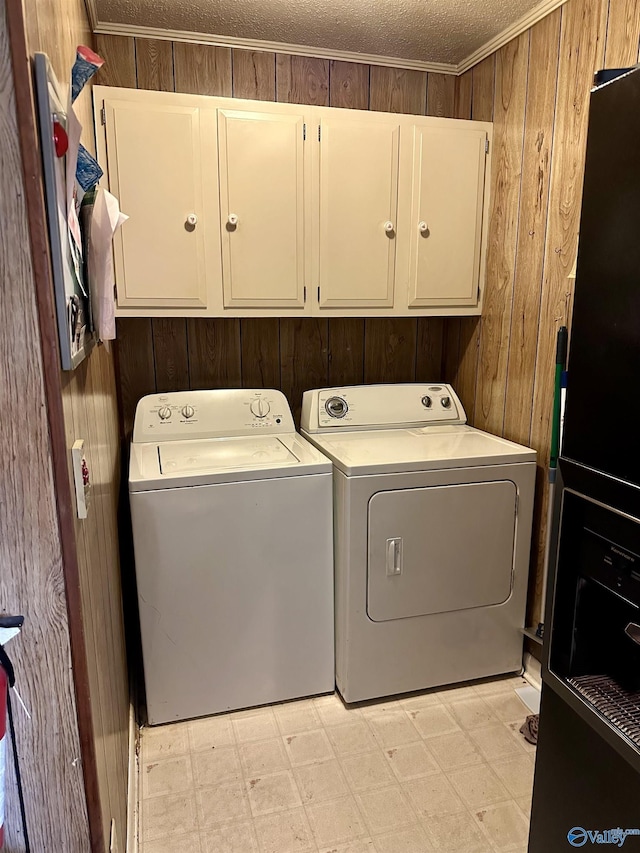 1212 Twin Lake Cir SW, Hartselle, AL 35640 - washroom with cabinet space, wooden walls, light floors, and independent washer and dryer