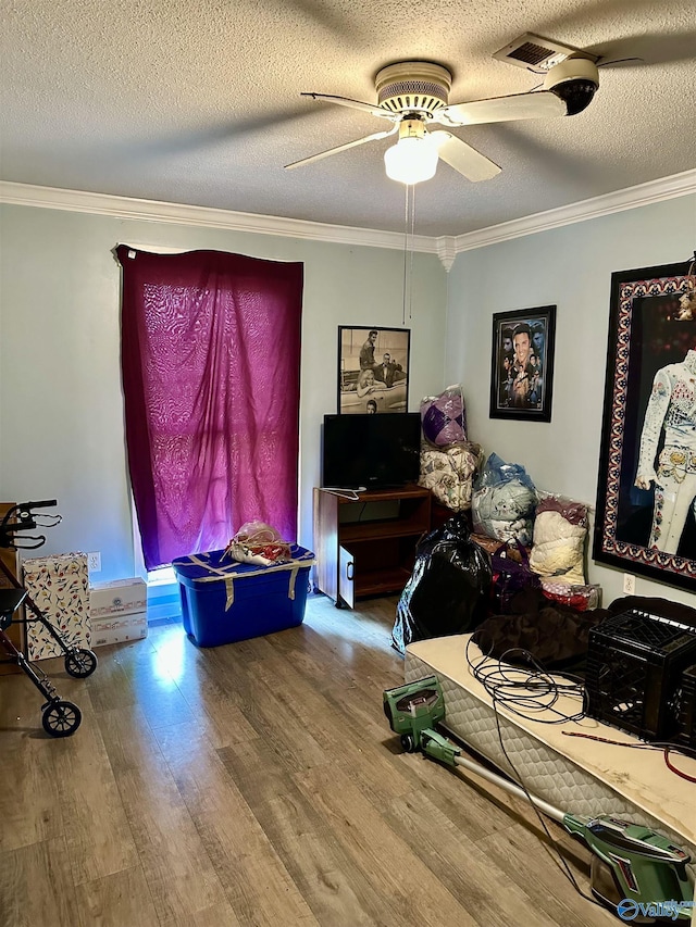 1212 Twin Lake Cir SW, Hartselle, AL 35640 - living area with wood finished floors, crown molding, a ceiling fan, and a textured ceiling