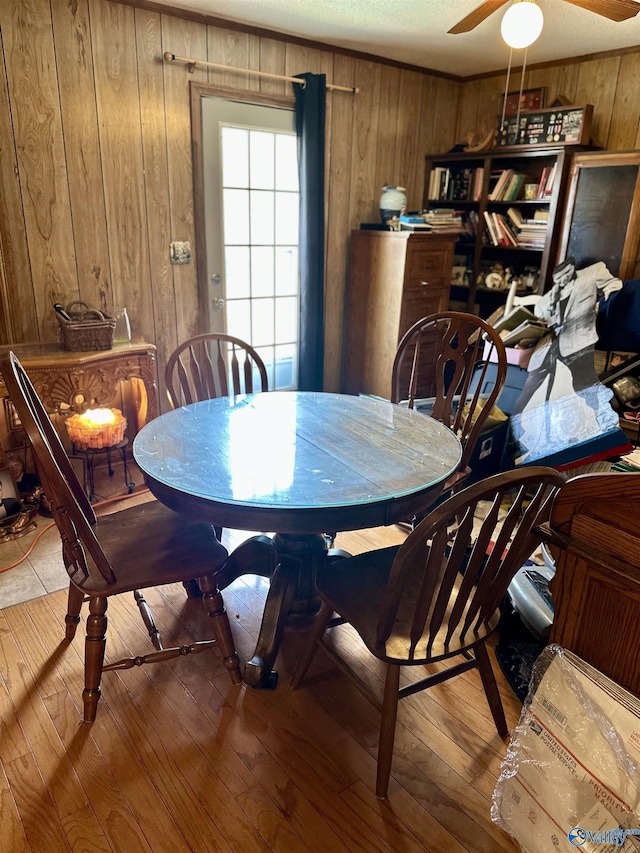 1212 Twin Lake Cir SW, Hartselle, AL 35640 - dining room featuring wood walls, a ceiling fan, and hardwood / wood-style floors
