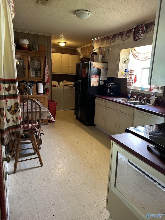 1212 Twin Lake Cir SW, Hartselle, AL 35640 - kitchen featuring washer and dryer, a sink, a textured ceiling, dark countertops, and light flooring