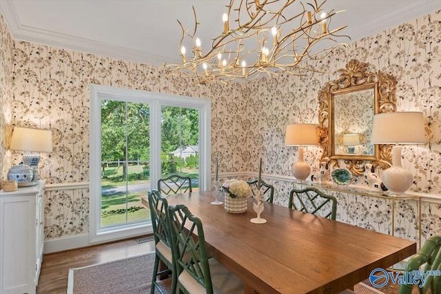 dining space featuring baseboards, ornamental molding, wood finished floors, and wallpapered walls