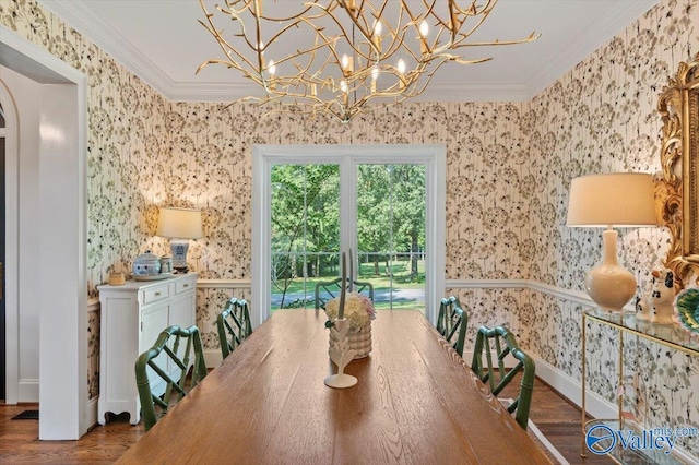 dining space with wallpapered walls, crown molding, and wood finished floors