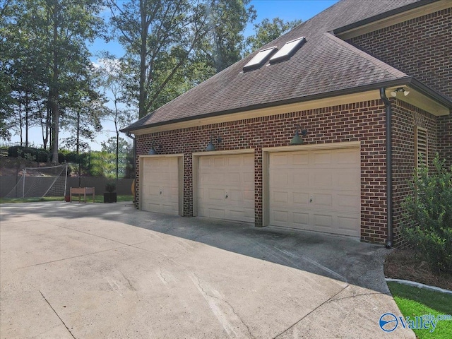 garage featuring concrete driveway