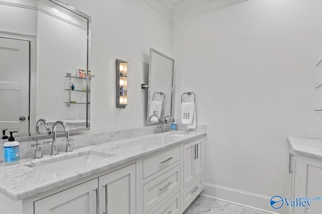 full bathroom with double vanity, crown molding, baseboards, and a sink