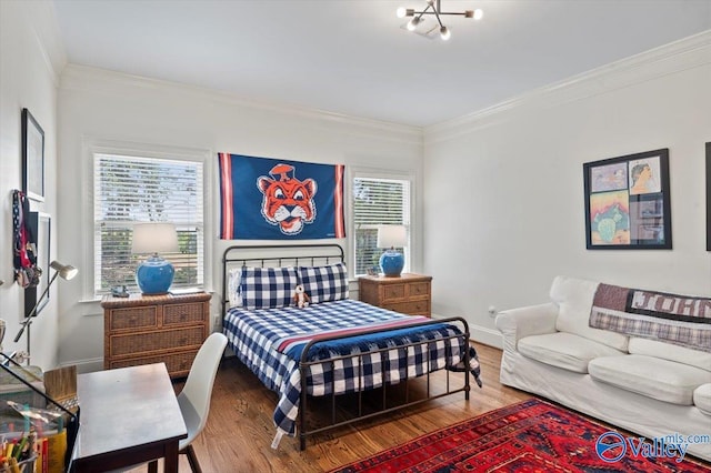 bedroom with multiple windows, crown molding, and wood finished floors