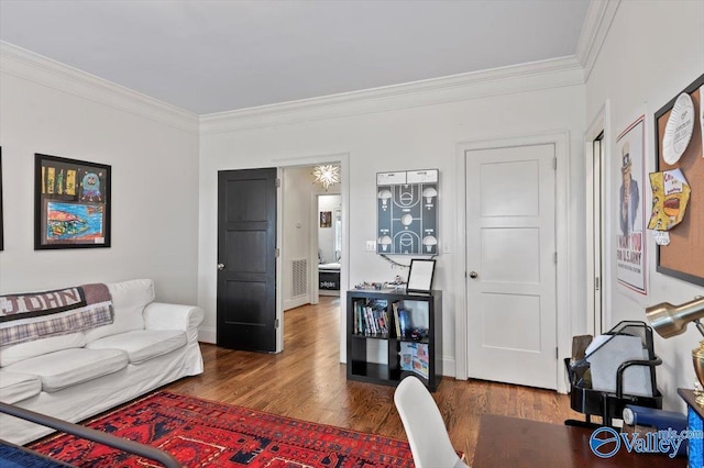 living room featuring baseboards, wood finished floors, and crown molding