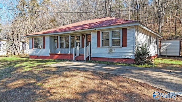 ranch-style house with cooling unit and a porch