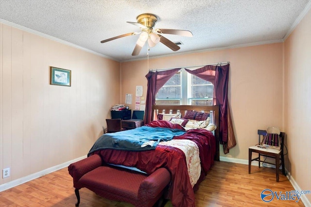 bedroom featuring crown molding, hardwood / wood-style flooring, a textured ceiling, and ceiling fan