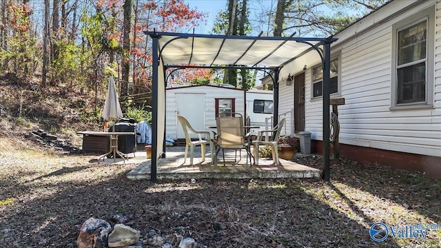 view of patio featuring a storage shed and a pergola