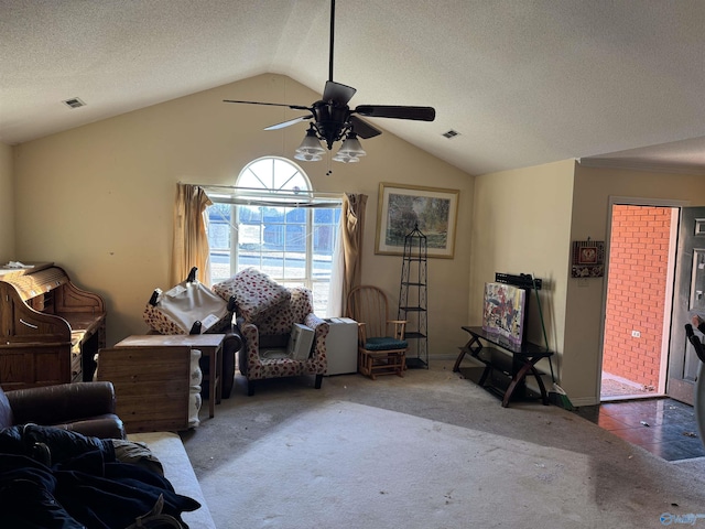 living room with vaulted ceiling, ceiling fan, a textured ceiling, and dark carpet