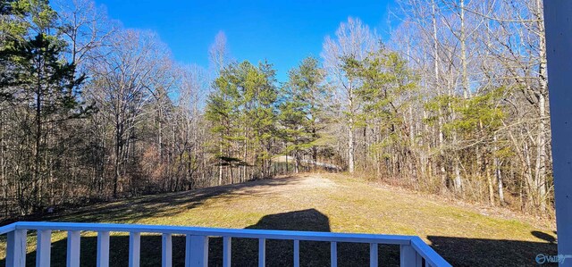 view of yard featuring a forest view