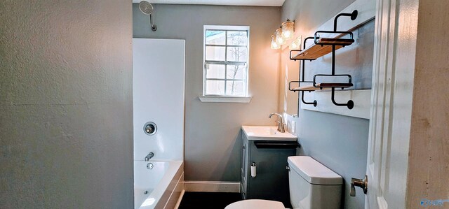 bathroom featuring shower / bathing tub combination, vanity, toilet, and baseboards