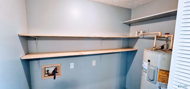 laundry area featuring water heater, a textured ceiling, and hookup for a washing machine